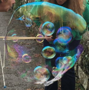 Blowing bubbles inside bubbles trick.