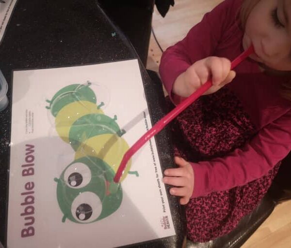 Blowing a caterpilla sculpture with bubbles free bubble activity for kids.