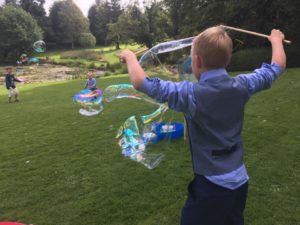 Wedding entertainer kids making bubbles in Bath.