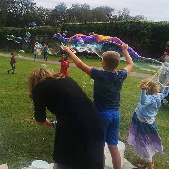 kids making bubbles with parents