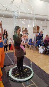 Kid inside a giant bubble at a party in Wotton-Under-Edge , Gloucestershire.