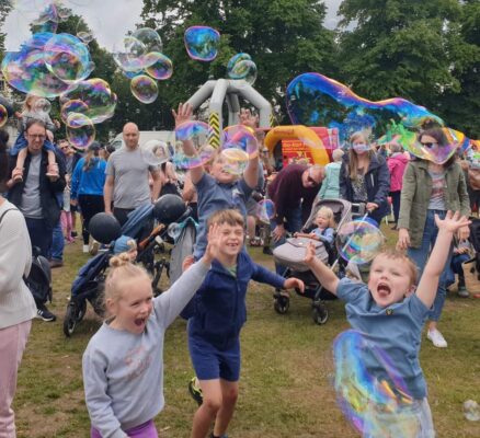kids chasing playing with bubbles at an event in Gloucester
