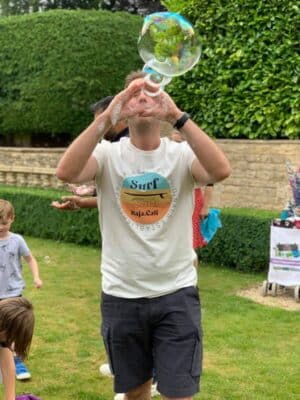 adult making bubbles with hands growns up love bubbles to