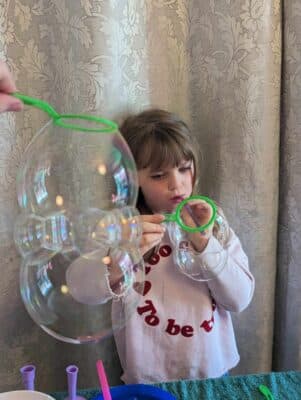 blowing bubble workshop learning magic tricks in a bubble science party.
