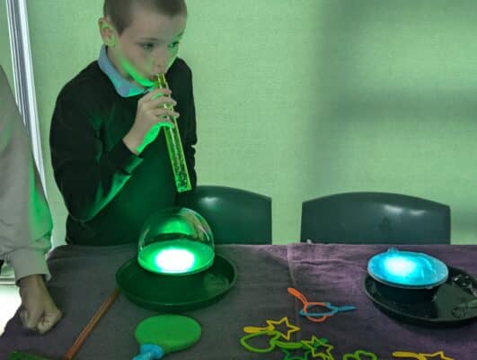 Blowing bubbles on lights playful workshop Cheltenham SEND