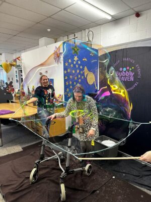 Children's entertainer. wheelchair pushchair inside a bubble