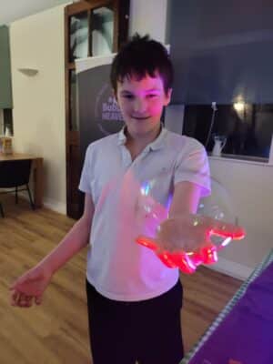 Kid holding a bubble sensory bubble workshop activity
