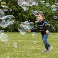 child chasing bubbles
