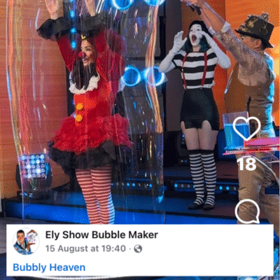Ely bubble show maker stand inside a bubble giant bubble solution