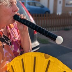 Bubble performer blowing a smoke tube and making a white smokey bubble