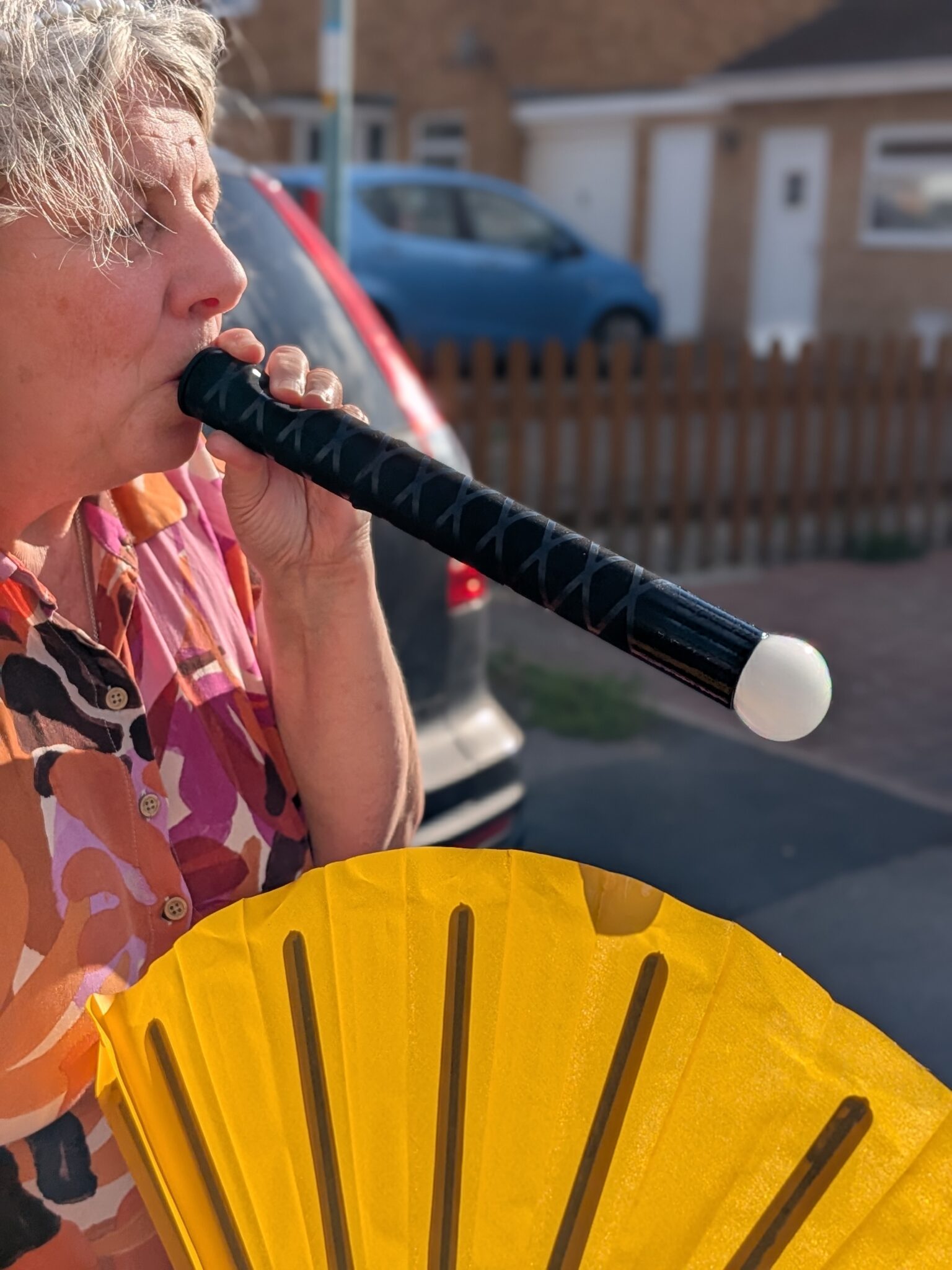 Bubble performer blowing a smoke tube and making a white smokey bubble